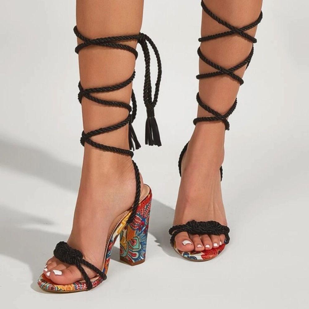 floral print open toe wrap around sandals with tassel decorations.